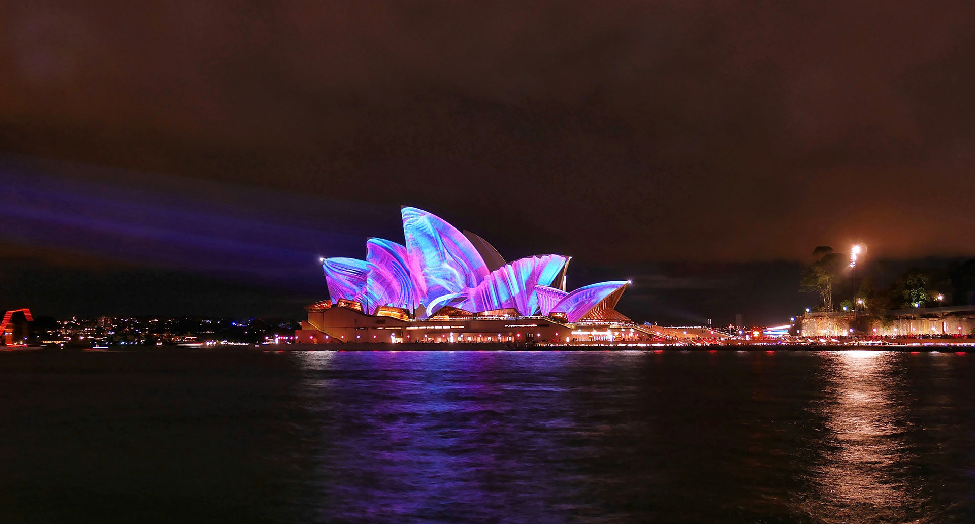 Sydney Opera House lit up for Vivid Sydney, viewed from a Journey Beyond River Cruise - KKDay Things to Do in Sydney for the family
